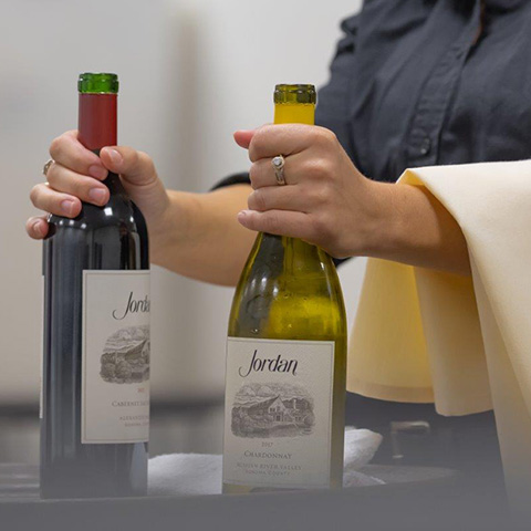 wine bottles in server's hands