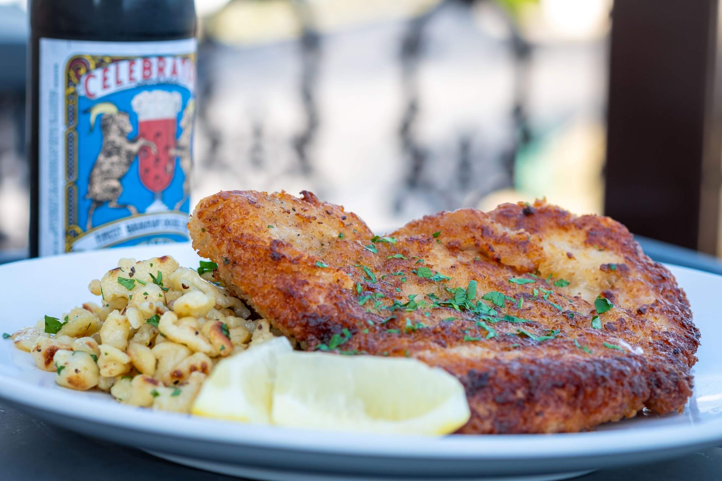 Golden breaded Schweineschnitzel with spätzle and lemon.